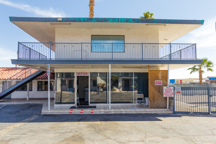 The motel office that was waiting behind the fence. On the far right is the area containing the cemented-in pool.